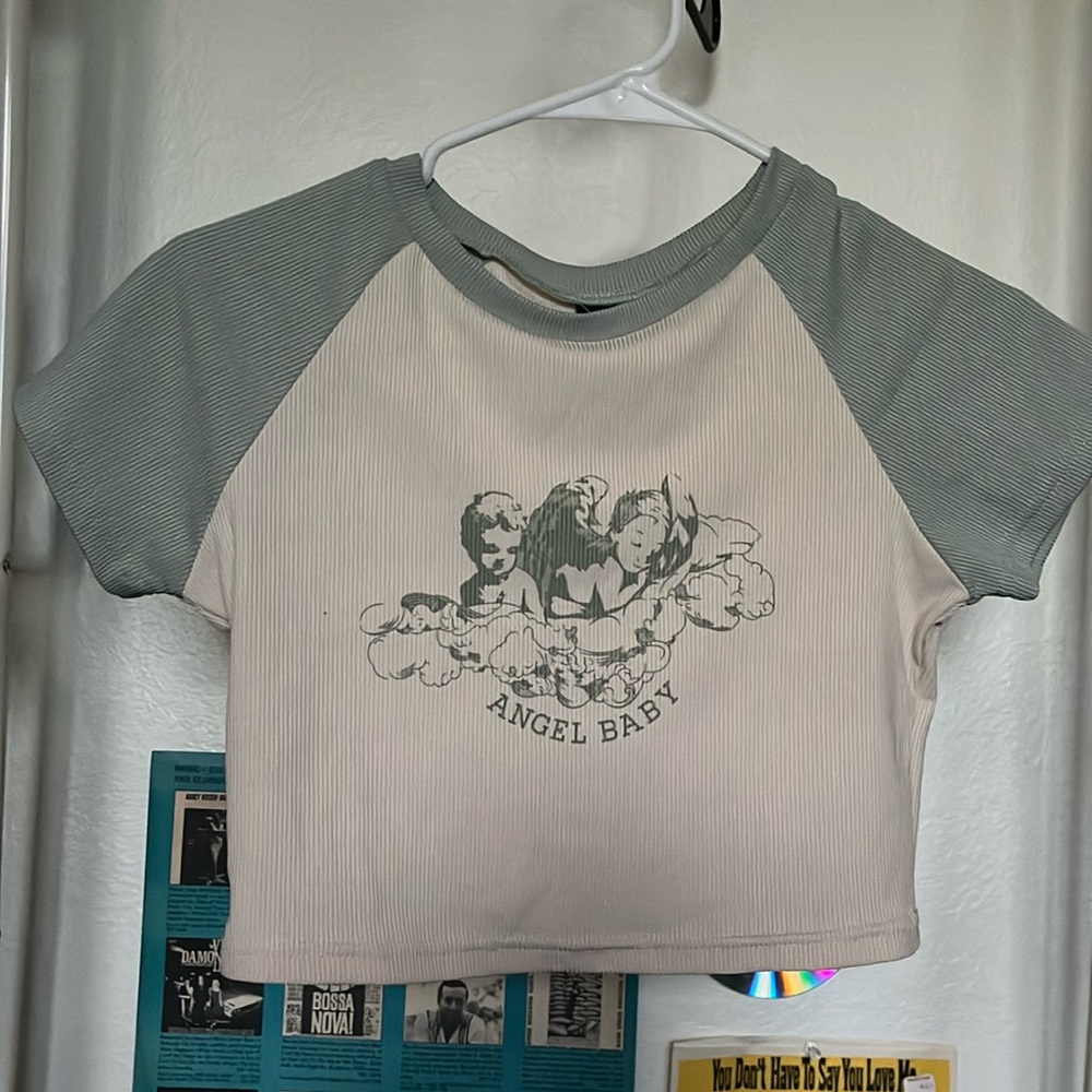 cream colored cropped tee with sage green sleeves